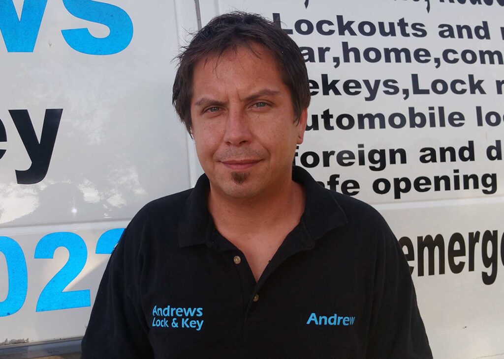 Andrew McColley, owner of Andrews Lock and Key, in a branded company shirt by his service van